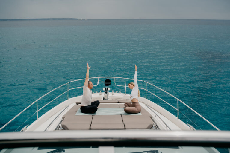 Two people stretching on a yacht in photography supplied by SENSES